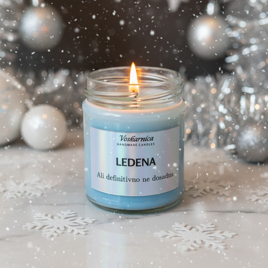 Candle in a glass jar with a label on a snowy background