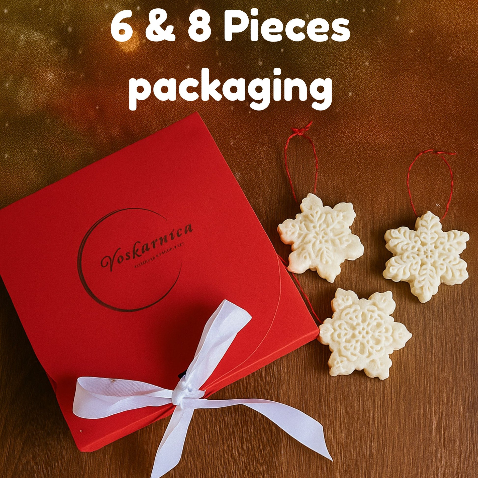 Red packaging with a white bow and snowflake-shaped wax melts on a wooden surface