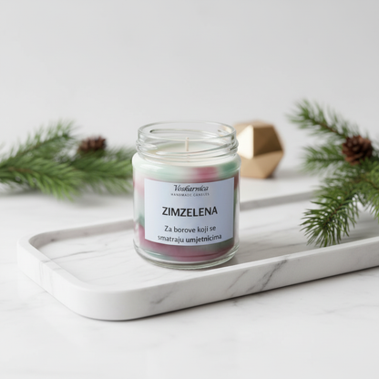 Candle in a glass jar labeled 'Zimzelena' on a marble tray with decorative elements.
